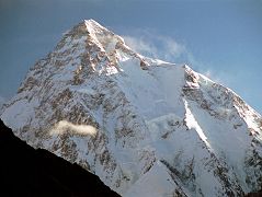 25 K2 Just After Sunrise From Concordia K2 shines in the early morning light from Concordia. The upper part of the K2 Southwest Pillar catches a bit of sun separating the west face in shadow from the sun descending the K2 South Face. The South-southeast Spur is partially in the sun and arrives at the K2 Shoulder on the right. On the far right is the Abruzzi Ridge / Spur, the East-southeast ridge, the normal ascent route. Called a suicidal route by Reinhold Messner, the K2 South Face or �Polish Line� was climbed for the first time on July 7, 1986 by Jerzy Kukuczka and Tadeusz Piotrowski. Piotrowski fell to his death on the descent.